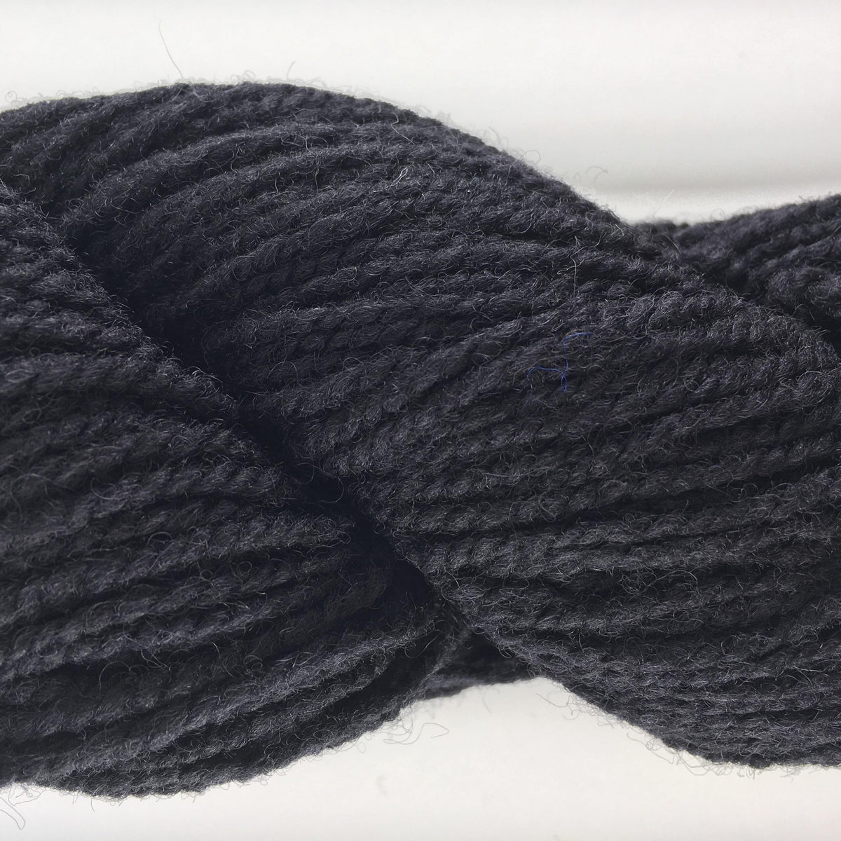 Close-up of a skein of black coloured wool yarn