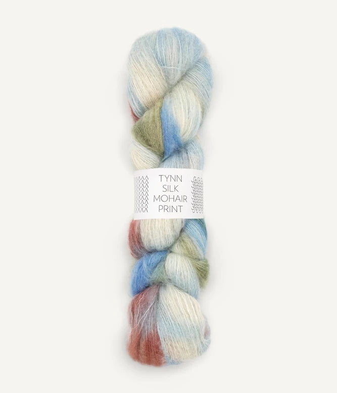 A skein of Tynn Silk Mohair print yarn in a blend of red, blue, green, and white colours