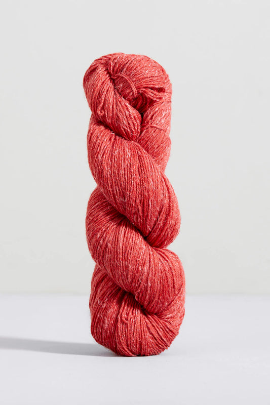 Medium red flecked skein of merino and linen yarn from Urth