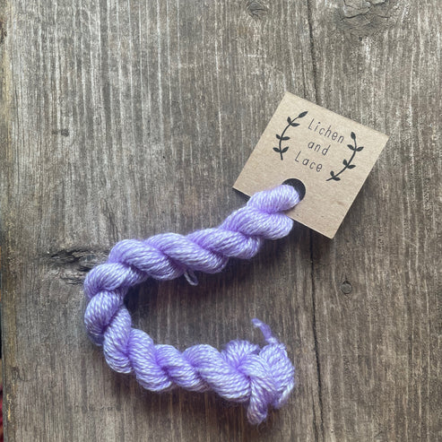 A skein of Amethyst purple embroidery yarn labelled 'Lichen and Lace'.