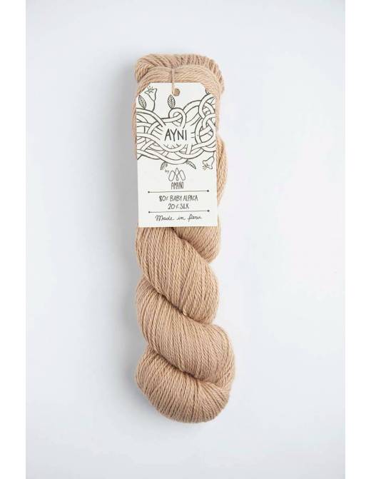 Beige skein of yarn with a label on a white background