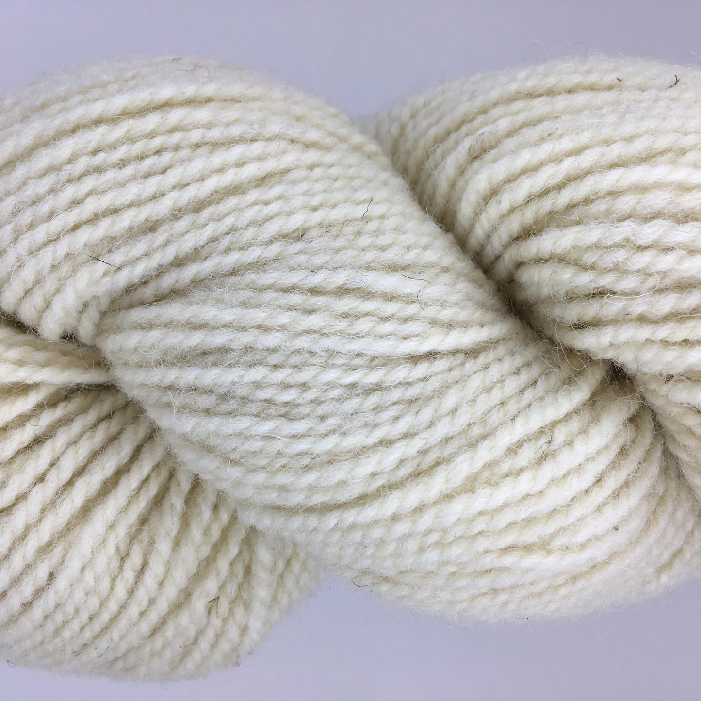 Close-up of a skein of white coloured wool yarn