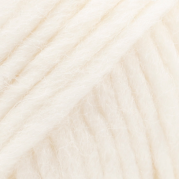 Close-up of a ball of cream-colored wool yarn from Drops