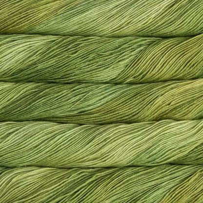 Close-up of twisted yarn strands in a variegated olive green and yellow-green colorway, filling the entire frame.