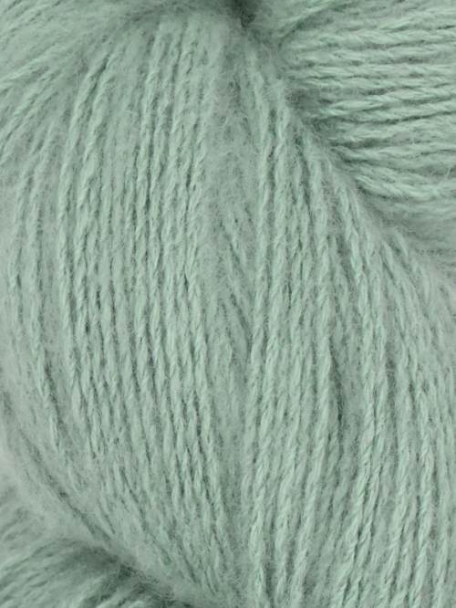 Close-up image of a skein of wildsage green colored cotton yarn.