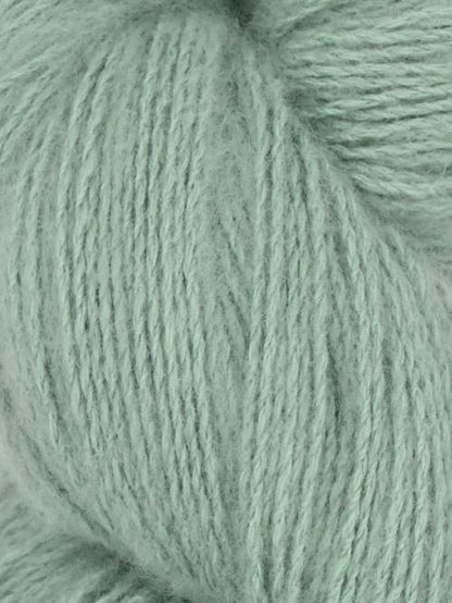 Close-up image of a skein of wildsage green colored cotton yarn.