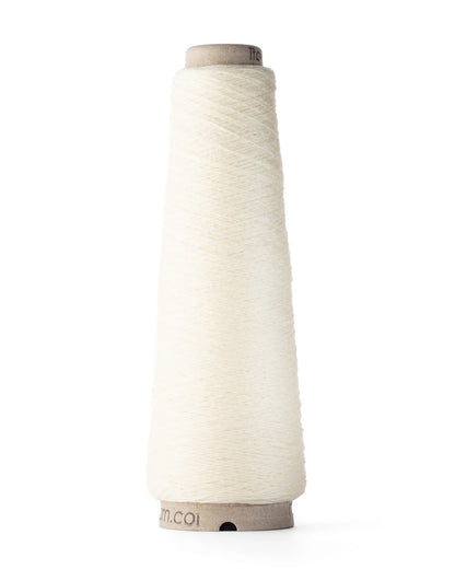 A spool of white merino wool fingering weight yarn.