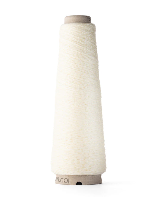 A spool of white merino wool fingering weight yarn.