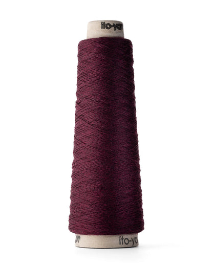 A spool of sangria red merino wool fingering weight yarn.
