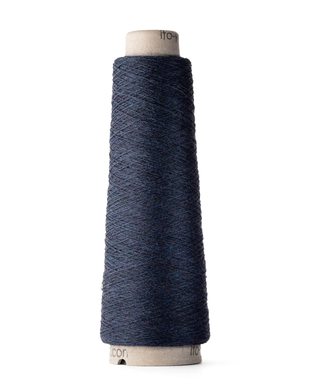 A spool of navy blue merino wool fingering weight yarn.