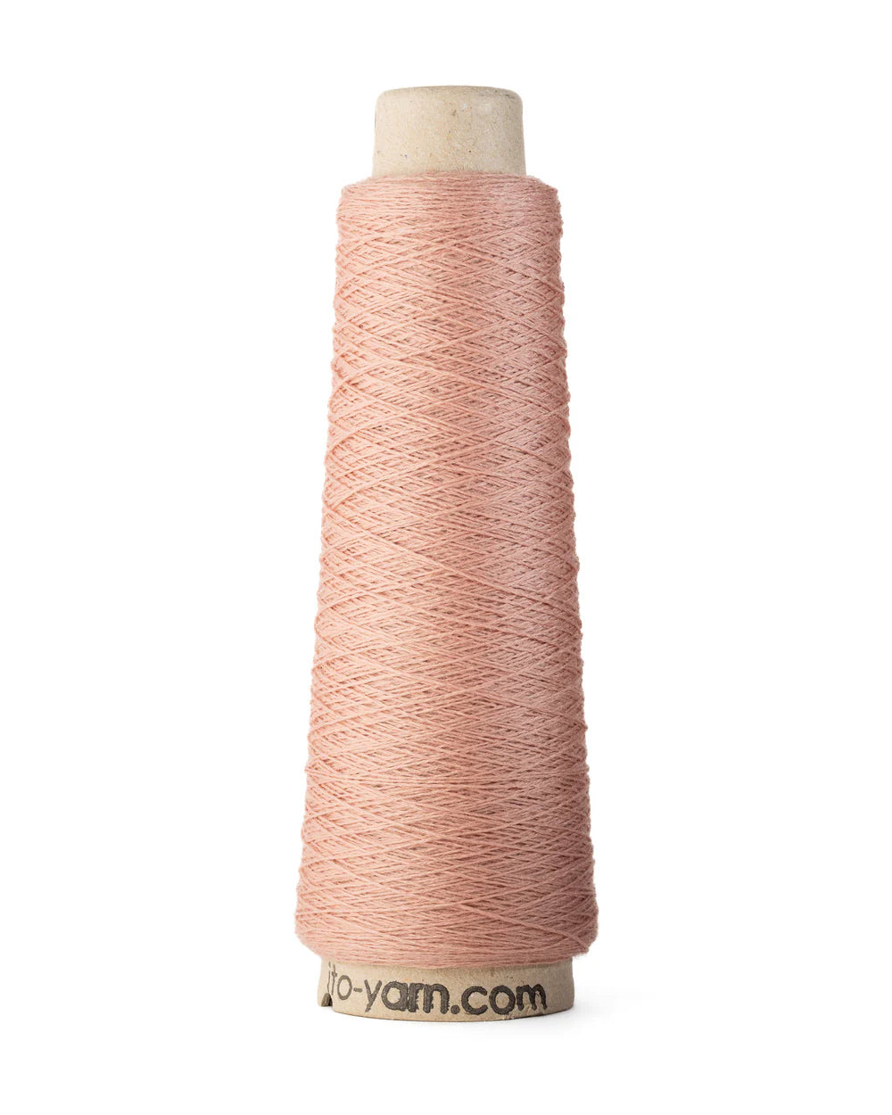 A spool of cherry blossom pink merino wool fingering weight yarn.