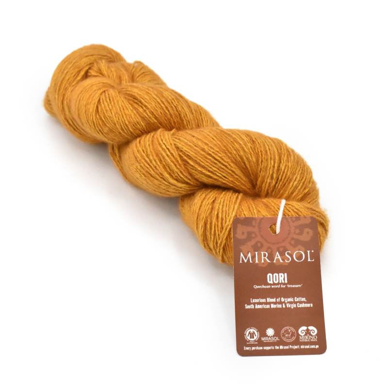 Mustard yellow skein of organic cotton yarn labeled 'Qori' by Mirasol. 