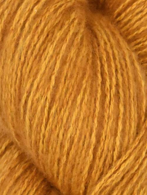 Close-up image of a skein of solace orange colored cotton yarn.