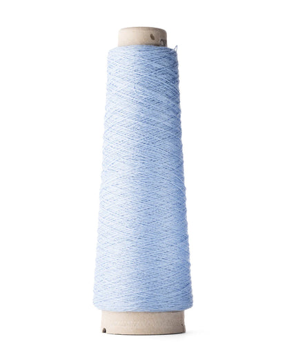 A spool of iron blue merino wool fingering weight yarn.