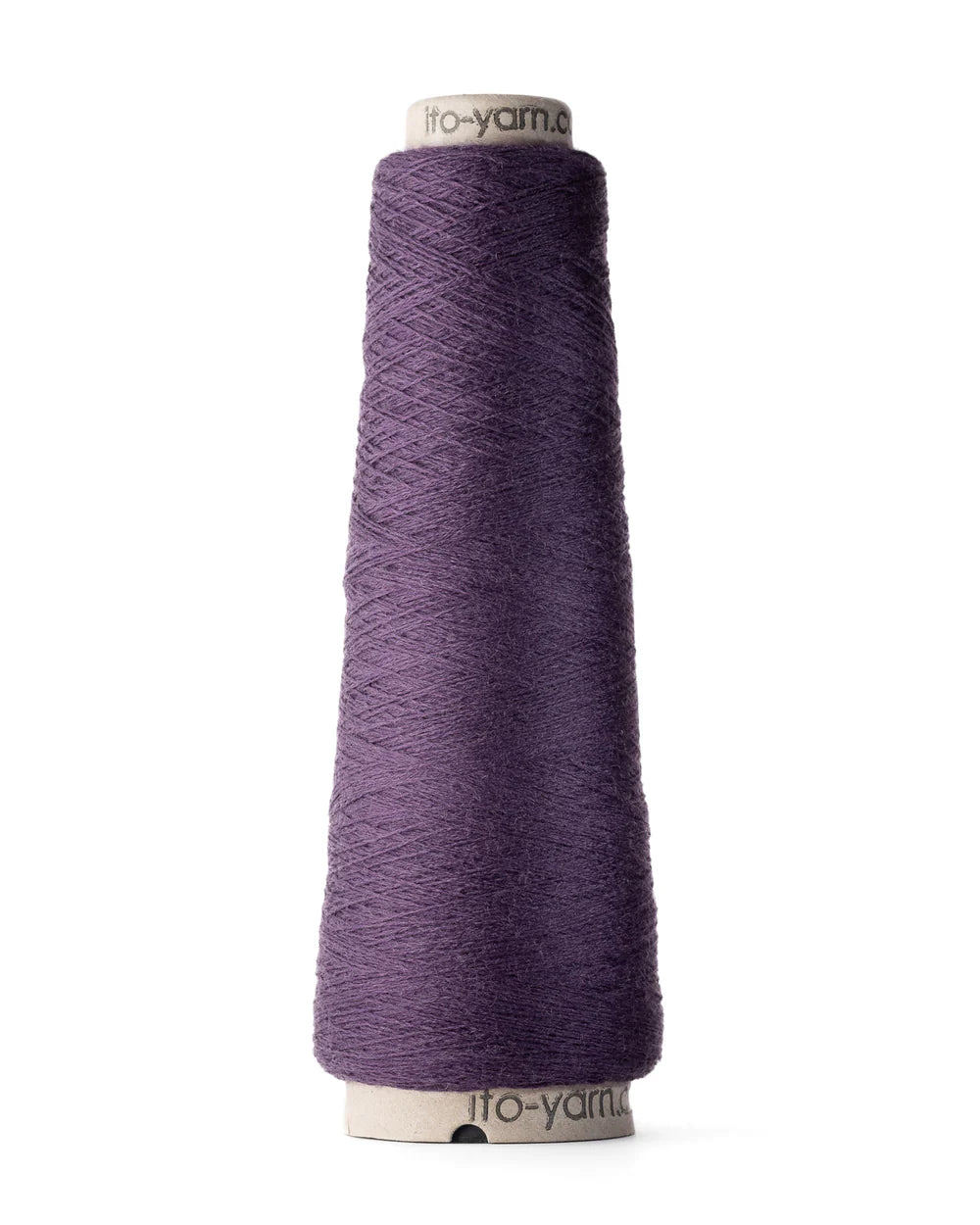 A spool of blackberry purple merino wool fingering weight yarn.