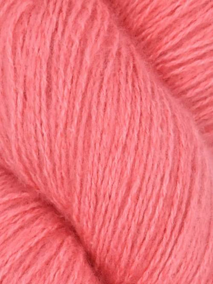 Close-up image of a skein of sumaq pink colored cotton yarn.