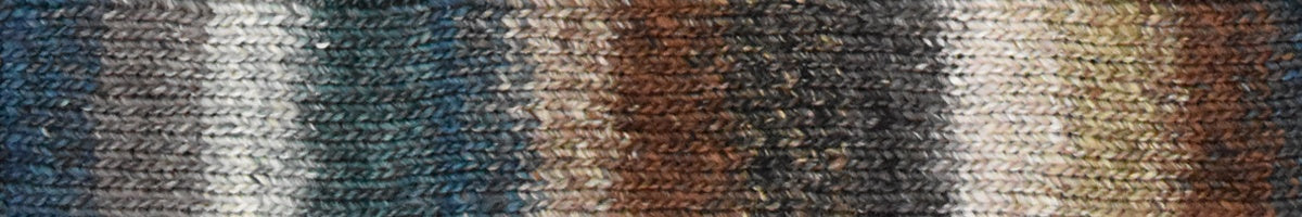 Knitted fabric swatch with a gradient of brown, gray, and blue colors.