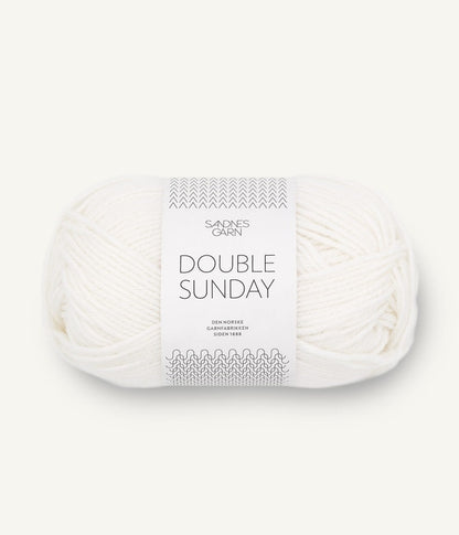 A ball of white coloured merino wool yarn labeled 'Double Sunday' by Sandnesgarn.