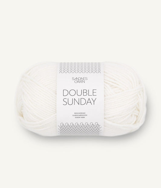 A ball of white coloured merino wool yarn labeled 'Double Sunday' by Sandnesgarn.