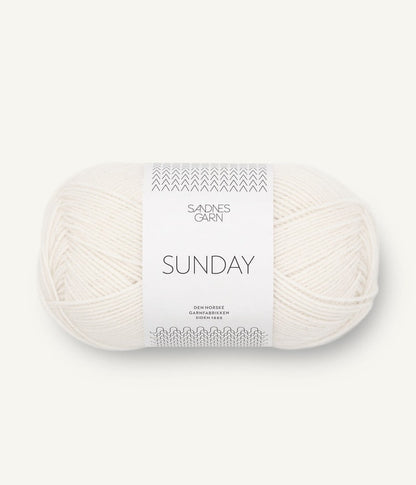 A ball of Sandnesgarn Sunday merino wool yarn in a white color, with packaging that includes the brand and product name.
