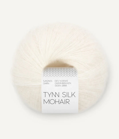 A ball of Tynn Silk Mohair yarn in an off  white color with a 'Tynn Silk Mohair' label from Sandnes Garn