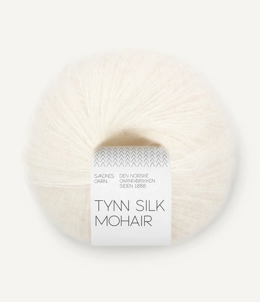 A ball of Tynn Silk Mohair yarn in an off  white color with a 'Tynn Silk Mohair' label from Sandnes Garn