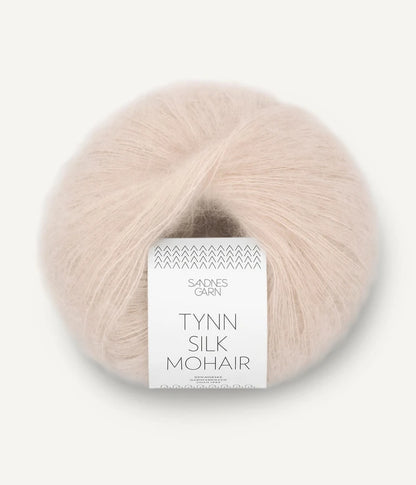 A ball of Tynn Silk Mohair yarn in a  beige color with a 'Tynn Silk Mohair' label from Sandnes Garn