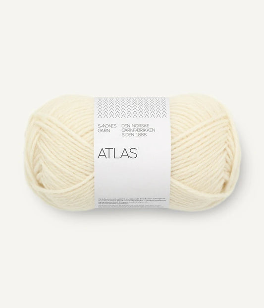 Ball of cream-colored yarn with 'Atlas' label on a white background