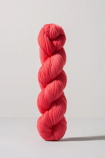 Bright pink skein of merino and nylon yarn from Urth