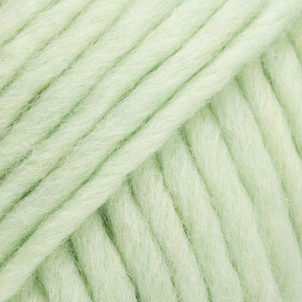 Close-up of a ball of pale light green-colored wool yarn from Drops