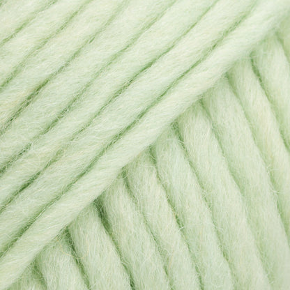 Close-up of a ball of pale light green-colored wool yarn from Drops