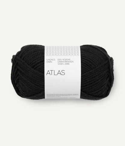 Black yarn ball with a white label on a white background