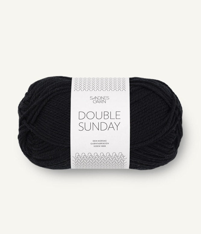 A ball of black coloured merino wool yarn labeled 'Double Sunday' by Sandnesgarn.