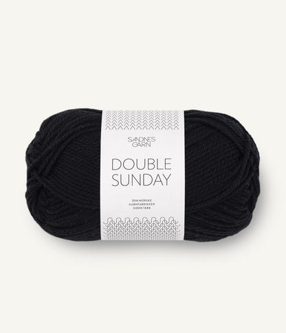 A ball of black coloured merino wool yarn labeled 'Double Sunday' by Sandnesgarn.