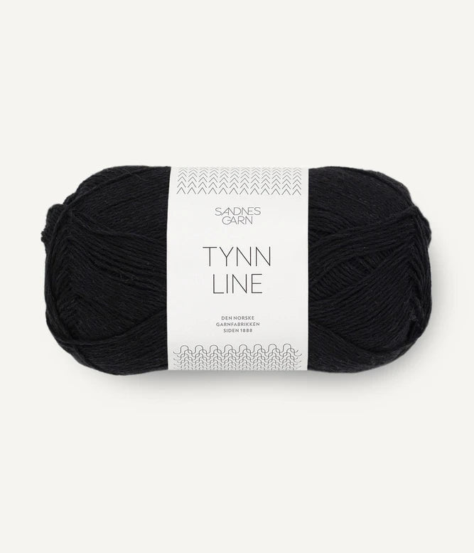 A ball of black cotton/linen/viscose yarn labeled 'TYNN LINE' by Sandnes Garn