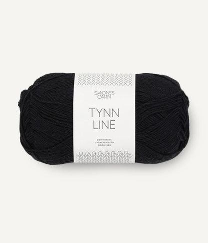 A ball of black cotton/linen/viscose yarn labeled 'TYNN LINE' by Sandnes Garn