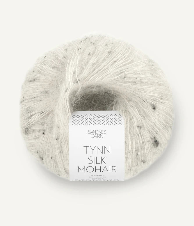 A ball of Tynn Silk Mohair yarn in a grey tweed color with a 'Tynn Silk Mohair' label from Sandnes Garn