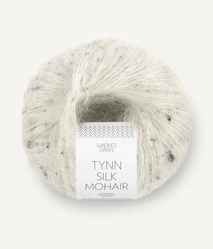 A ball of Tynn Silk Mohair yarn in a grey tweed color with a 'Tynn Silk Mohair' label from Sandnes Garn