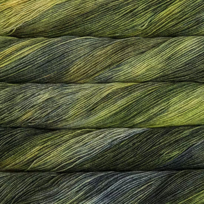 Close-up of folded yarn strands showing a variegated color pattern of olive green, dark gray, and black.