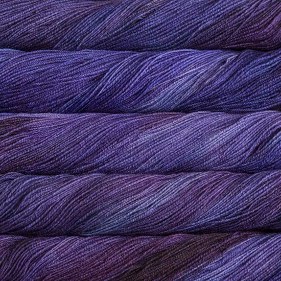 Close-up of purple yarn skeins stacked on top of each other