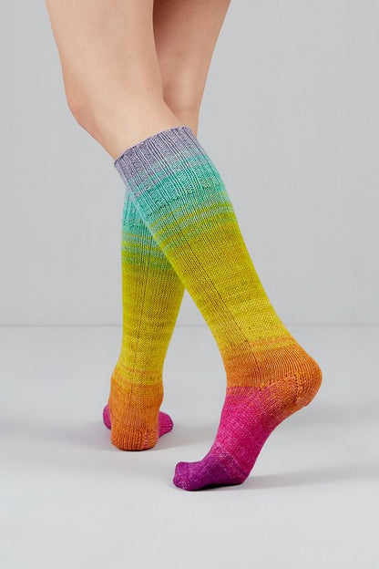 Knitted socks in pastel rainbow tones from Urth Yarns in the Gusto line