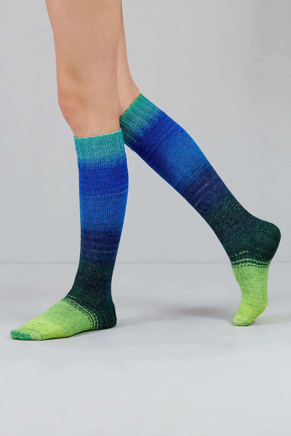 Knitted socks in blue and green tones from Urth Yarns in the Gusto line