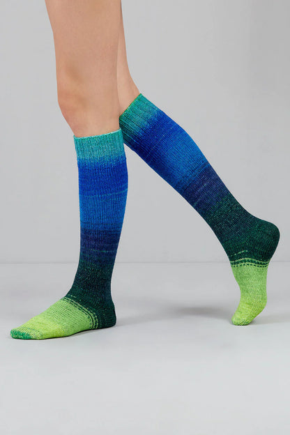 Knitted socks in blue and green tones from Urth Yarns in the Gusto line
