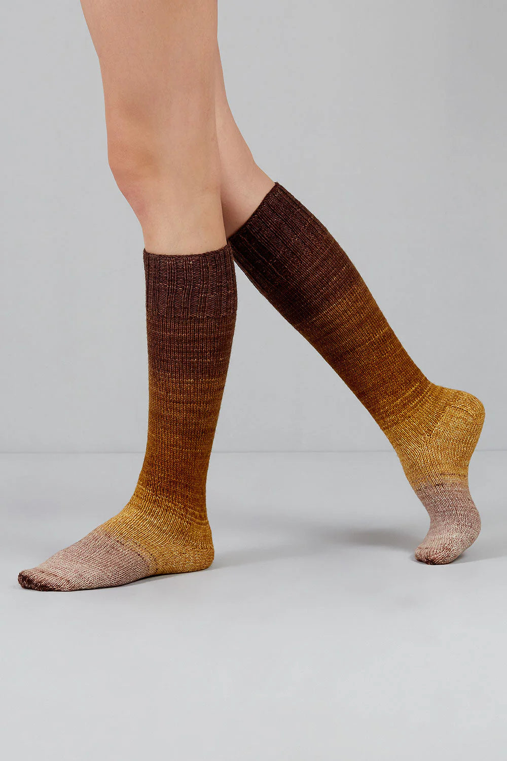 Knitted socks in tan and brown tones from Urth Yarns in the Gusto line