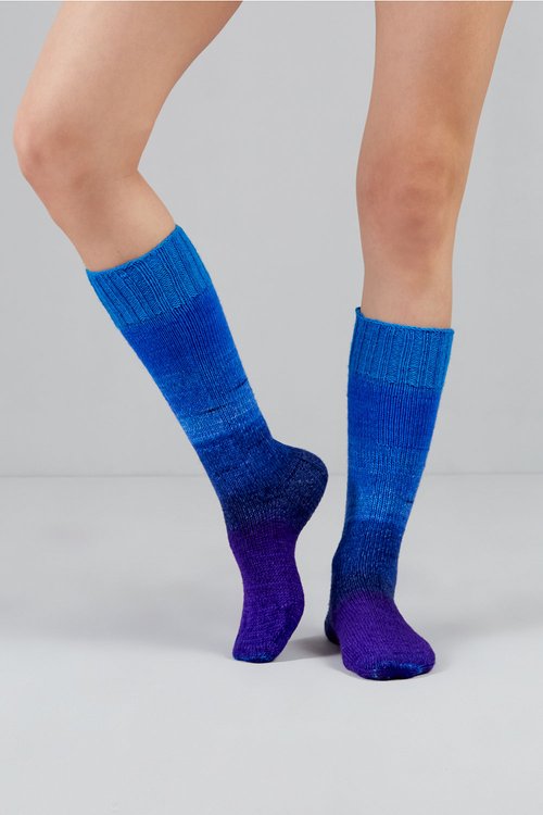 Knitted socks in purple and blue tones from Urth Yarns in the Gusto line