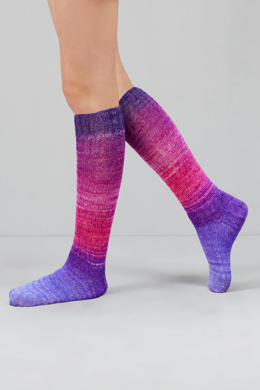 Knitted socks in pink and purple tones from Urth Yarns in the Gusto line