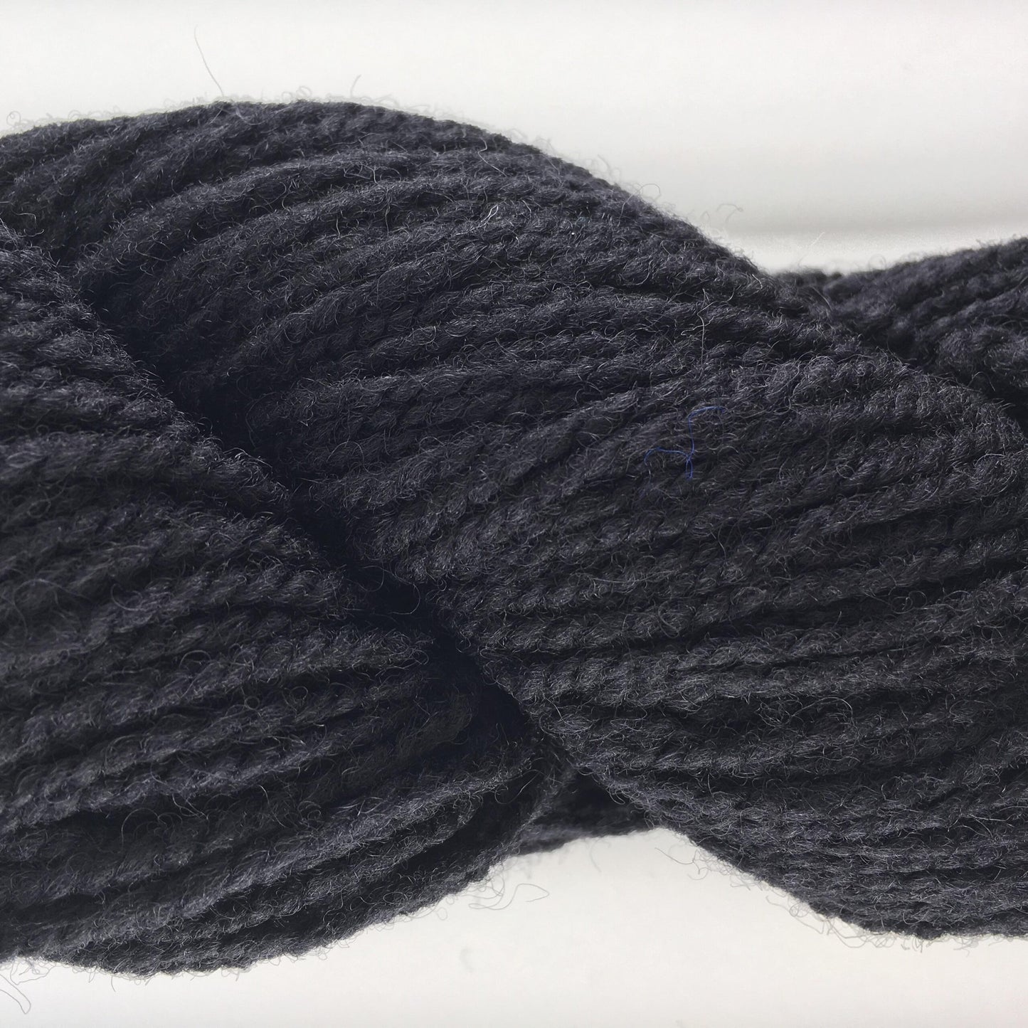 Close-up of a skein of black coloured wool yarn