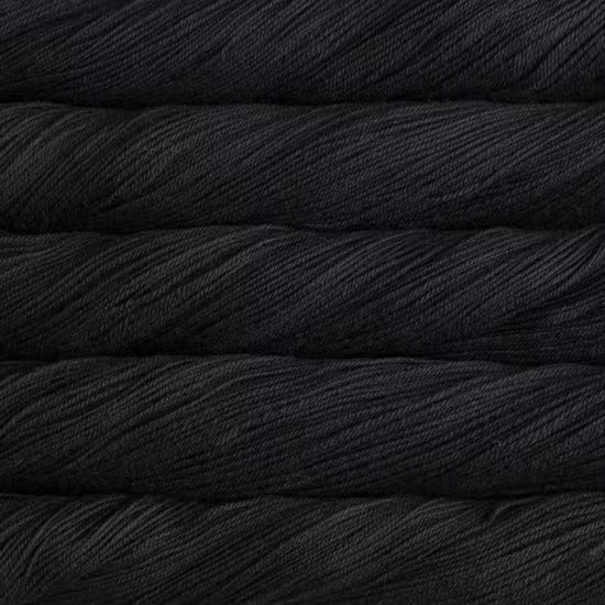 A close-up texture shot of stacked black yarn skeins, showing the twisted plies and soft sheen of the fiber.
