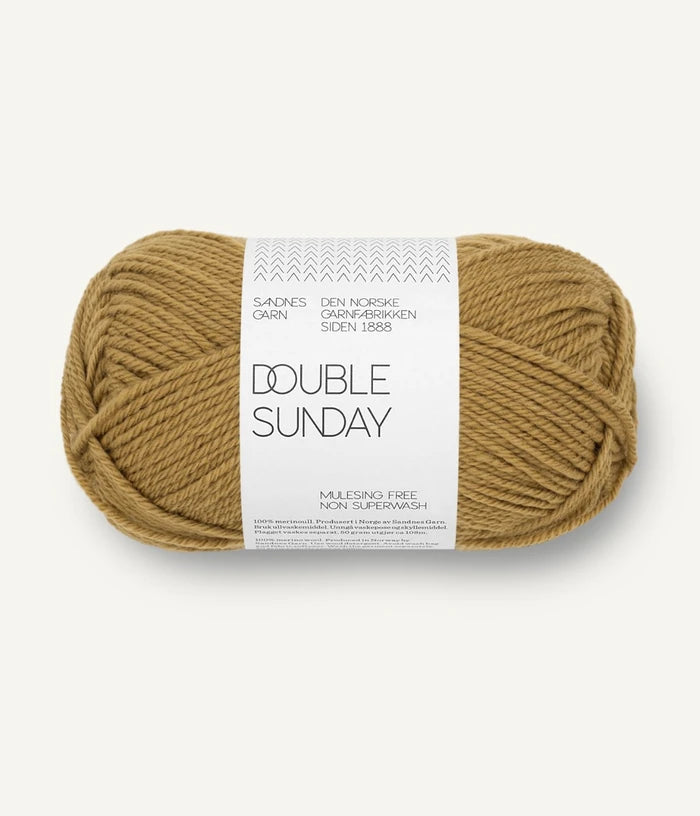 A ball of gold coloured merino wool yarn labeled 'Double Sunday' by Sandnesgarn.