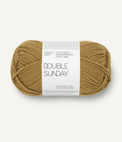 A ball of gold coloured merino wool yarn labeled 'Double Sunday' by Sandnesgarn.